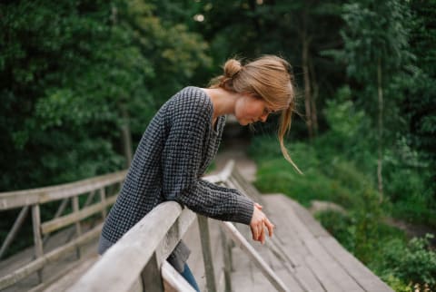 Upset Woman Looking Downcast on a Nature Path Upset Woman Looking Downcast on a Nature Path