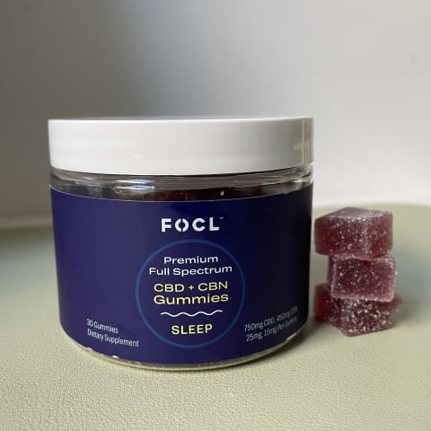 Best CBD Gummies for Sleep FOCL CBD+CBN Gummies on white background next to stack of gummies taken by tester