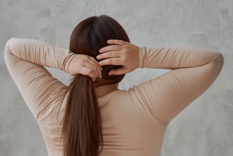 Woman touching her hair Woman touching her hair