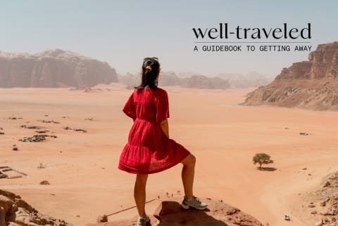 Woman in red dress looks out over the desert Woman in red dress looks out over the desert