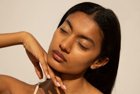 young women with glowy skin and eyes closed and tilted facing sunlight young women with glowy skin and eyes closed and tilted facing sunlight