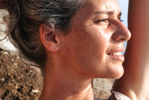 Closeup portrait of a woman with gray hair and fine lines