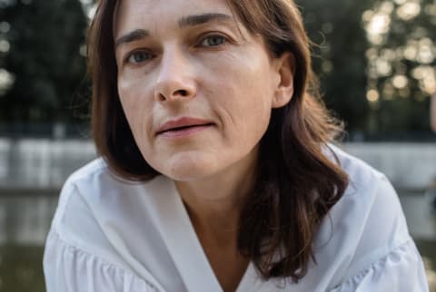 Mature woman with frown lines looks into camera close up Mature woman with frown lines looks into camera close up