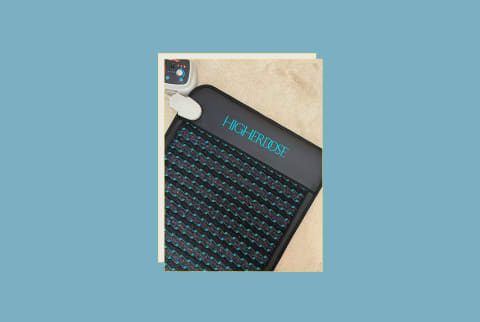 HigherDose PEMF Mat Review Hero with mat on author's floor with remote control and blue backgorund HigherDose PEMF Mat Review Hero with mat on author's floor with remote control and blue backgorund