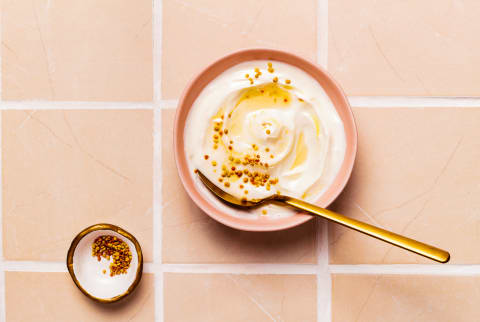 Bowl of Greek Yogurt topped with honey, bee pollen and honeycomb Bowl of Greek Yogurt topped with honey, bee pollen and honeycomb
